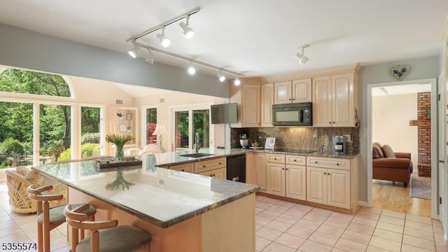 10 Stacy Dr, Montgomery Twp, NJ 08502 - kitchen featuring black appliances, a sink, a breakfast bar, light tile patterned flooring, and decorative backsplash