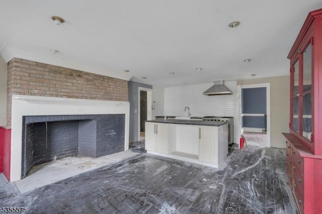 29 S Valley Rd, West Orange Twp, NJ 07052 - kitchen featuring wall chimney range hood, dark countertops, a fireplace, glass insert cabinets, and ornamental molding