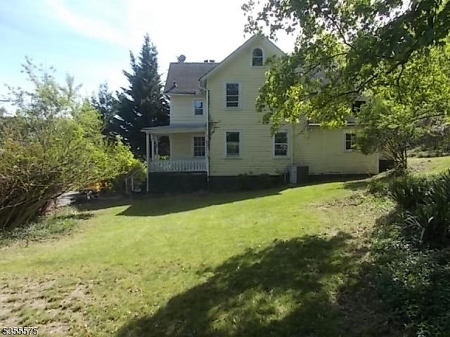 29 S Valley Rd, West Orange Twp, NJ 07052 - rear view of property featuring a lawn, a porch, and central AC unit