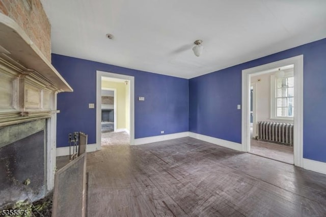 29 S Valley Rd, West Orange Twp, NJ 07052 - unfurnished living room with radiator, a high end fireplace, baseboards, and wood finished floors