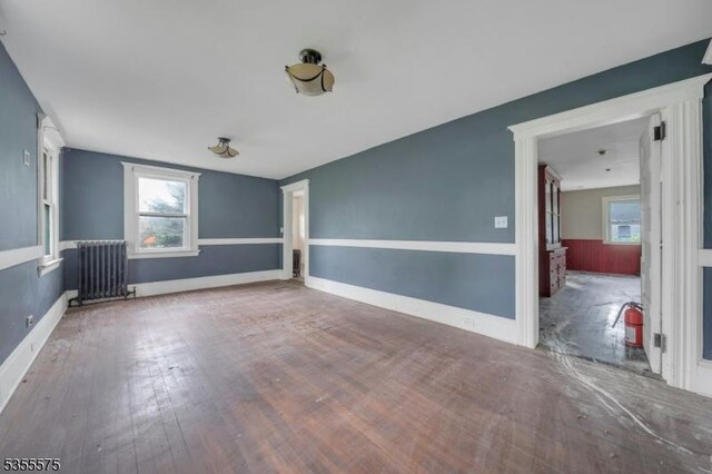 29 S Valley Rd, West Orange Twp, NJ 07052 - spare room with radiator heating unit, wood finished floors, and baseboards