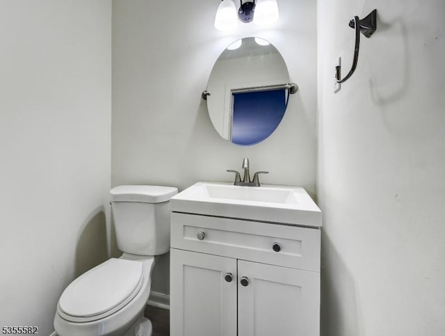 half bathroom with toilet and vanity