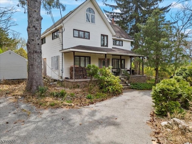 view of front of property with a porch and a chimney