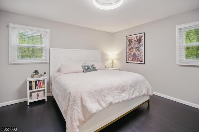 bedroom featuring wood finished floors and baseboards