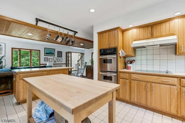 kitchen featuring under cabinet range hood, double oven, light tile patterned floors, black electric stovetop, and recessed lighting