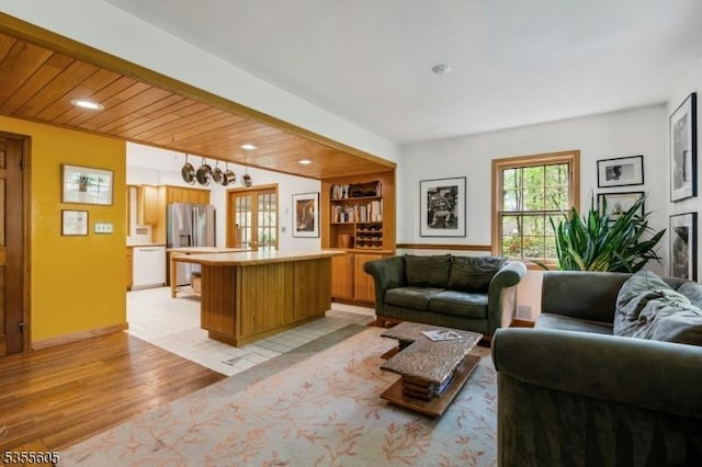 living area with light wood finished floors and recessed lighting
