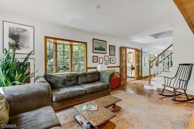 living area featuring wood finished floors and stairs