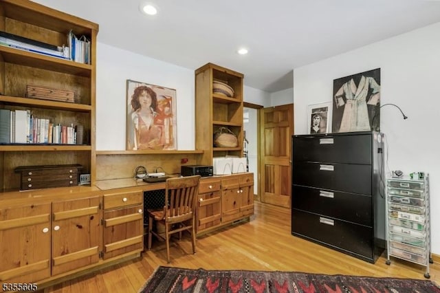 office space with built in desk, light wood-style floors, and recessed lighting