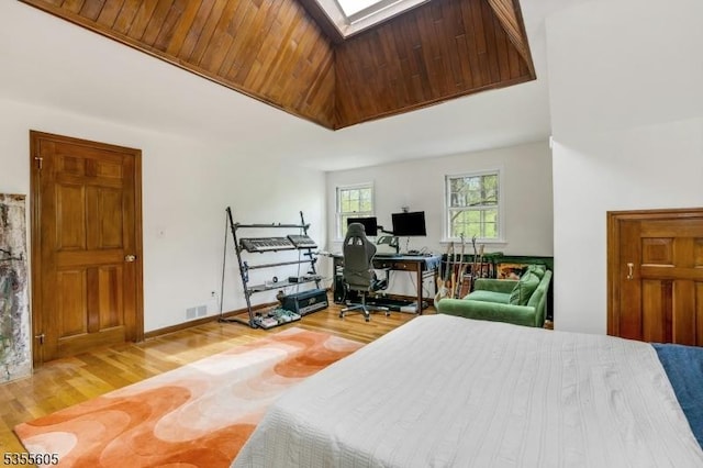 bedroom with light wood-type flooring, a desk, and high vaulted ceiling