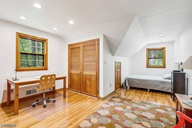 bedroom featuring wood finished floors, baseboards, recessed lighting, a closet, and a desk