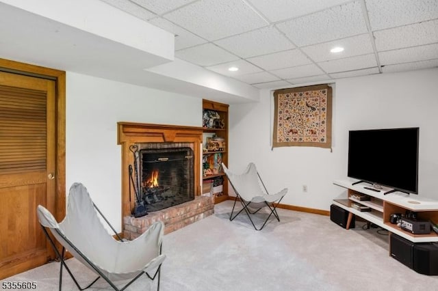 carpeted living room with recessed lighting, a fireplace, a paneled ceiling, and baseboards