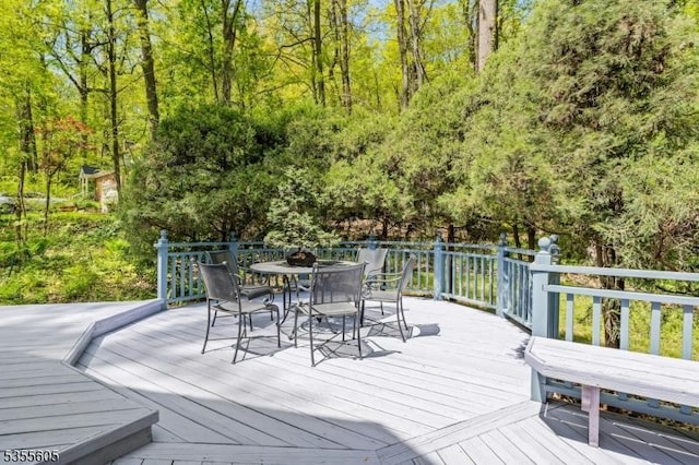 wooden deck featuring outdoor dining space