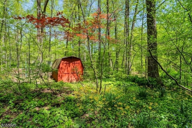 view of shed featuring a forest view