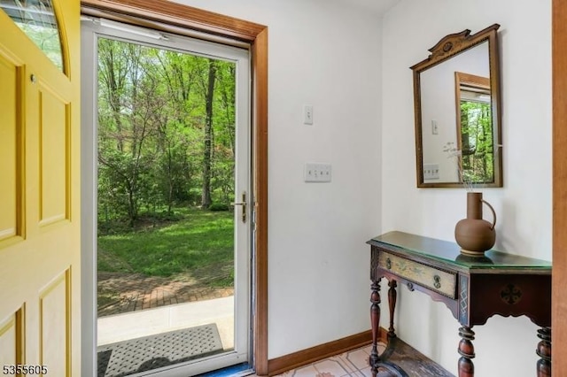 doorway to outside with baseboards