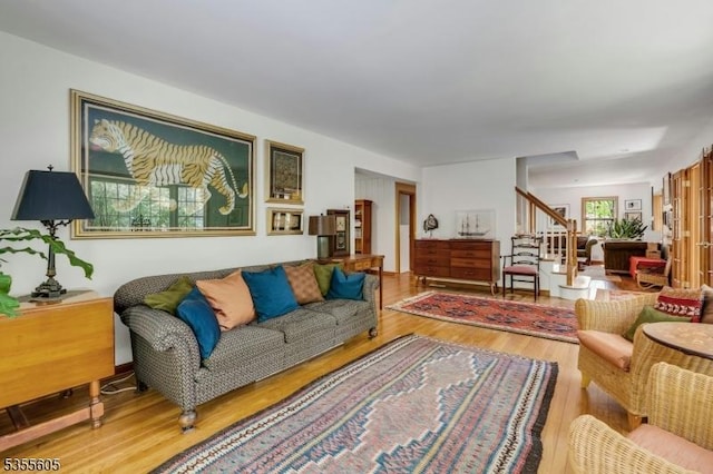 living area with wood finished floors and stairs
