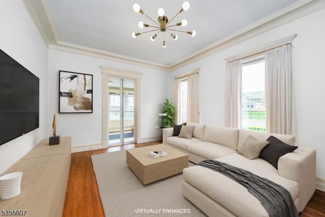 living room featuring a chandelier, wood finished floors, ornamental molding, and baseboards