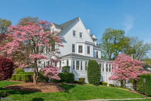 view of property exterior with a lawn and stucco siding