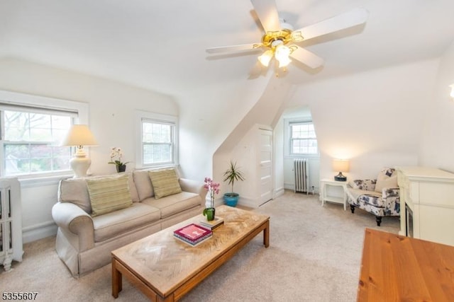 living room featuring radiator heating unit, light carpet, ceiling fan, and lofted ceiling