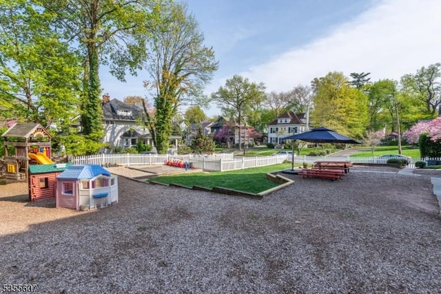 communal playground with fence and a residential view