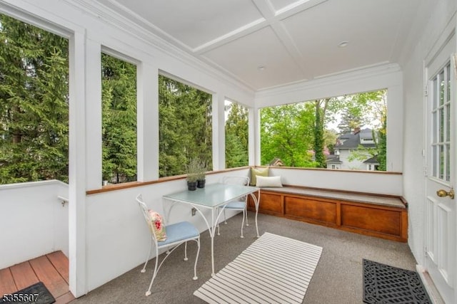 sunroom with coffered ceiling, crown molding, and carpet floors