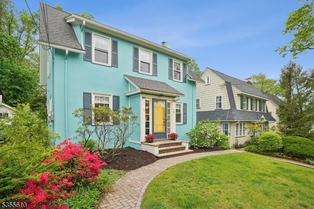 view of front of home featuring a front lawn and stucco siding