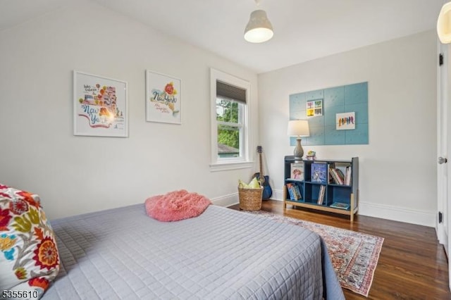 bedroom with wood finished floors and baseboards