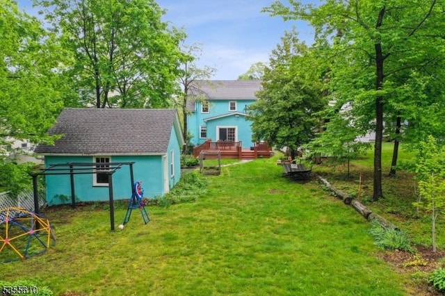 view of green lawn with a deck