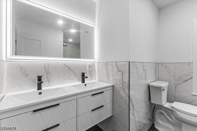 bathroom with toilet, tile walls, and a sink