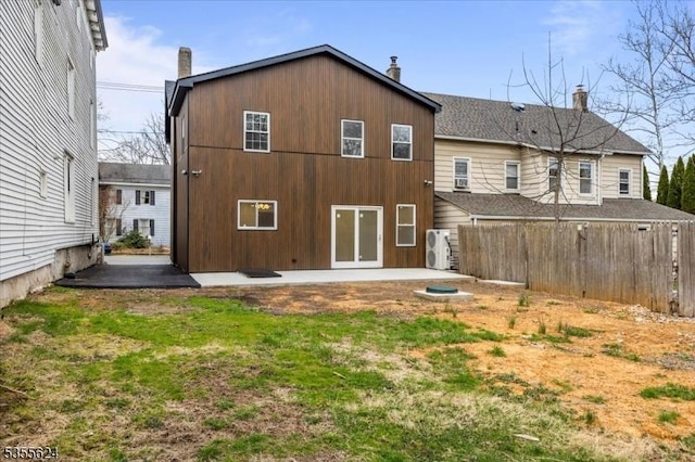 rear view of property featuring fence, a chimney, and a patio area