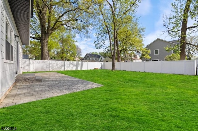view of yard with a fenced backyard and a patio area
