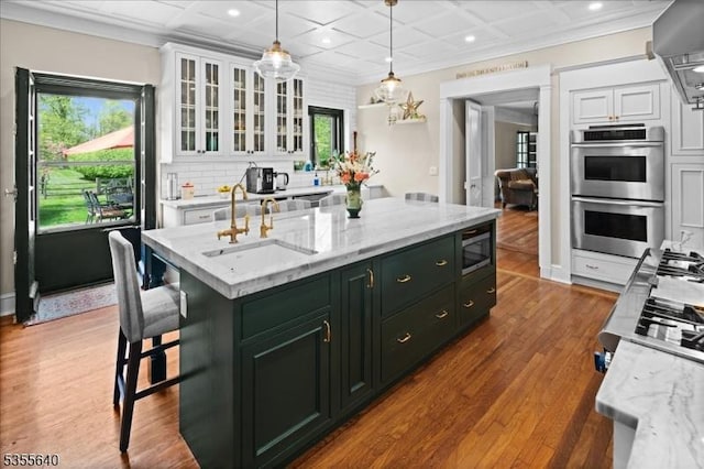 1330 Great Rd, Montgomery Twp, NJ 08540 - kitchen featuring double oven, white cabinets, recessed lighting, a center island with sink, and dark wood-style floors