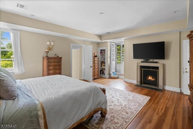 1330 Great Rd, Montgomery Twp, NJ 08540 - bedroom featuring multiple windows, wood finished floors, a fireplace with flush hearth, and baseboards
