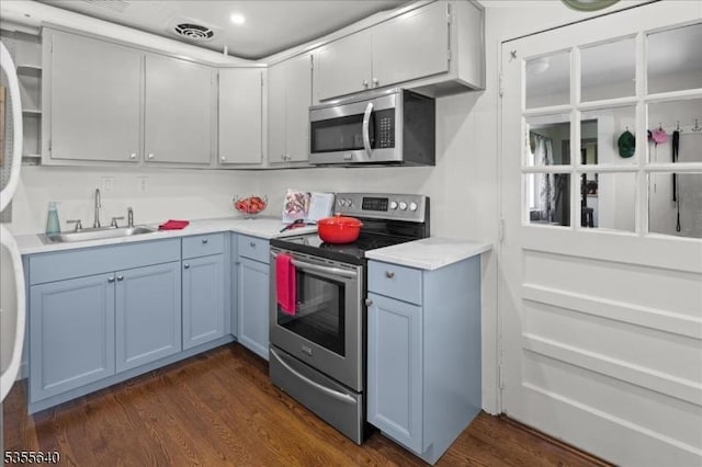 1330 Great Rd, Montgomery Twp, NJ 08540 - kitchen with appliances with stainless steel finishes, a sink, light countertops, dark wood-style flooring, and blue cabinets