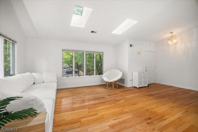 102 Westchester Ter, Clinton Twp, NJ 08801 - living area with vaulted ceiling, a skylight, healthy amount of natural light, light wood-style floors, and a chandelier