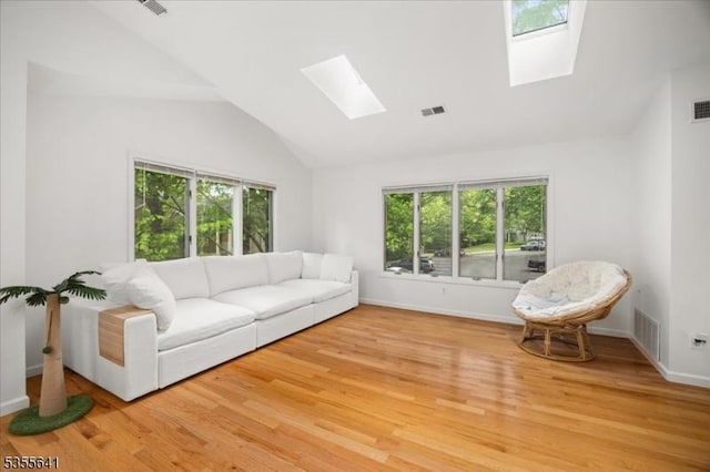 102 Westchester Ter, Clinton Twp, NJ 08801 - living area with a skylight, vaulted ceiling, healthy amount of natural light, and light wood-style flooring