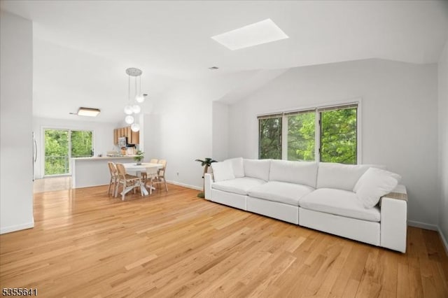 102 Westchester Ter, Clinton Twp, NJ 08801 - living room with vaulted ceiling, light wood-type flooring, a skylight, and baseboards