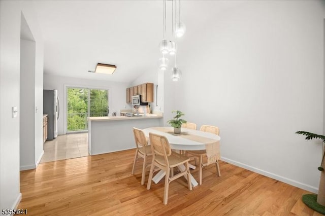 102 Westchester Ter, Clinton Twp, NJ 08801 - dining area featuring light wood-style flooring, baseboards, and vaulted ceiling