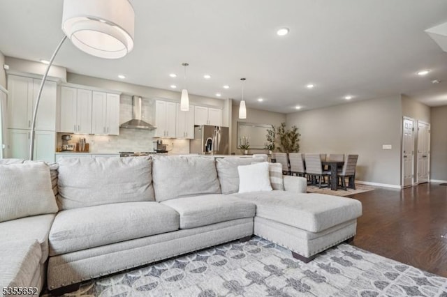 living room with baseboards, recessed lighting, and wood finished floors