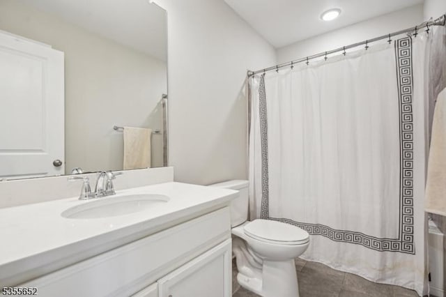 bathroom with tile patterned floors, toilet, curtained shower, and vanity