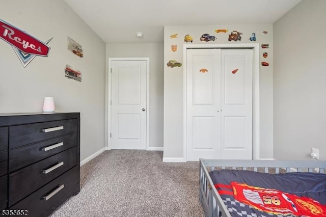 carpeted bedroom with baseboards and a closet
