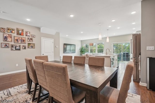 dining room featuring baseboards, dark wood-type flooring, and recessed lighting