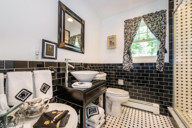 40 Hemlock Ave, Andover Twp, NJ 07860 - bathroom with a baseboard heating unit, tile walls, a shower stall, toilet, and wainscoting