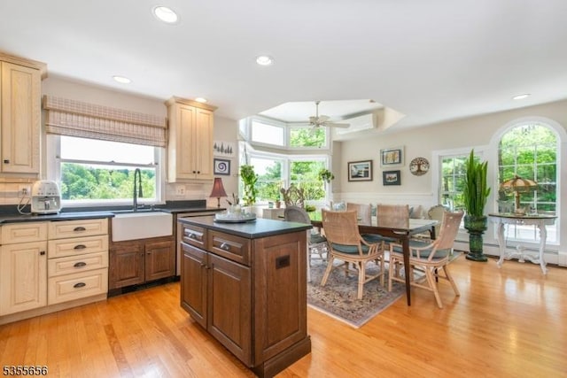 40 Hemlock Ave, Andover Twp, NJ 07860 - kitchen with a sink, dark countertops, light wood-style floors, a ceiling fan, and a kitchen island