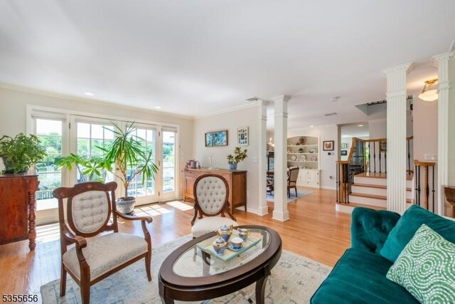 40 Hemlock Ave, Andover Twp, NJ 07860 - living area with ornate columns, light wood-style floors, ornamental molding, and stairway