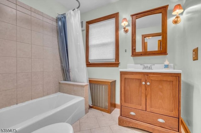 bathroom featuring radiator heating unit, tile patterned floors, vanity, shower / tub combo, and toilet