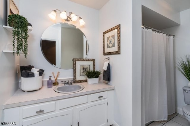 full bath with toilet, vanity, and tile patterned flooring