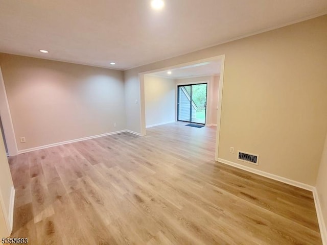 spare room with light wood-style flooring, recessed lighting, and baseboards