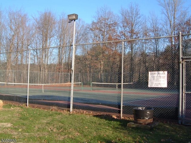 view of tennis court with fence