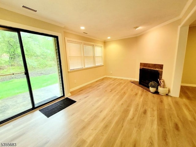 unfurnished living room with ornamental molding, baseboards, light wood-type flooring, a fireplace, and recessed lighting