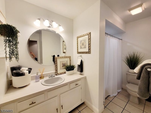 full bathroom with tile patterned flooring, toilet, vanity, and baseboards